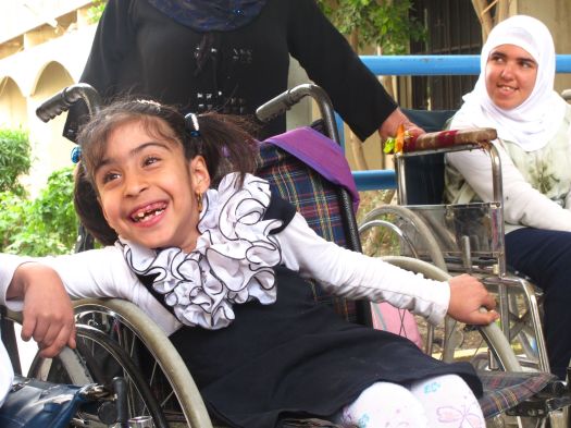 Noor, in a happy moment, at the school for disabled kids she attends in Baghdad. March, 2013